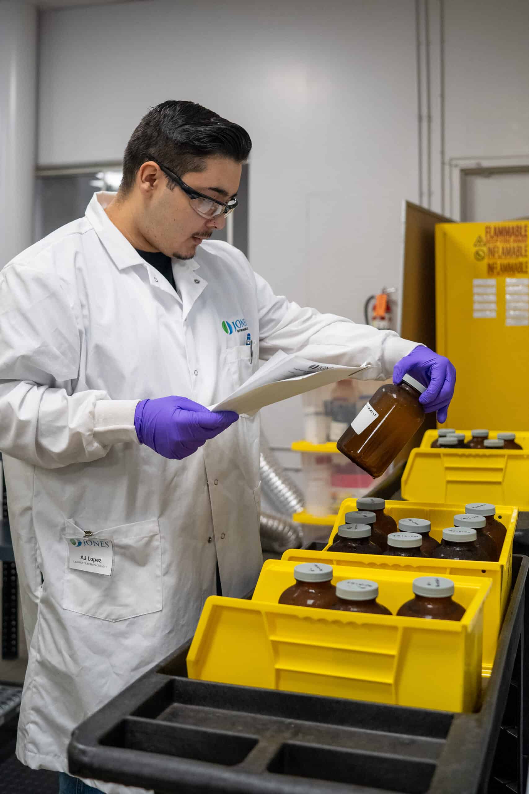 Chemist sorting sample jars from a cooler at the Jones Environmental lab