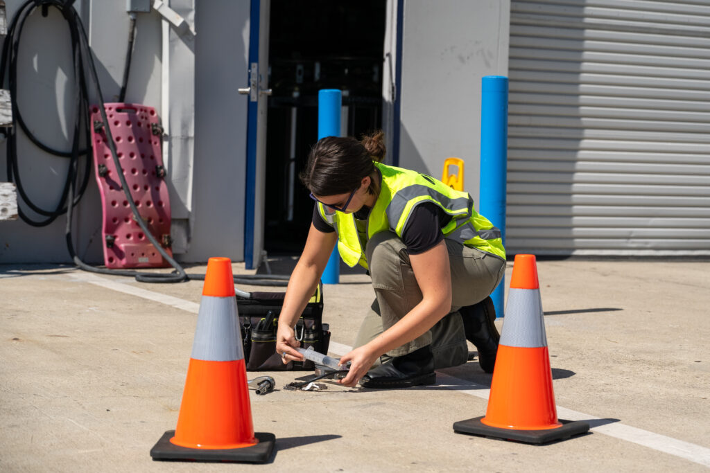 Jones Environmental field technician sampling on a job site