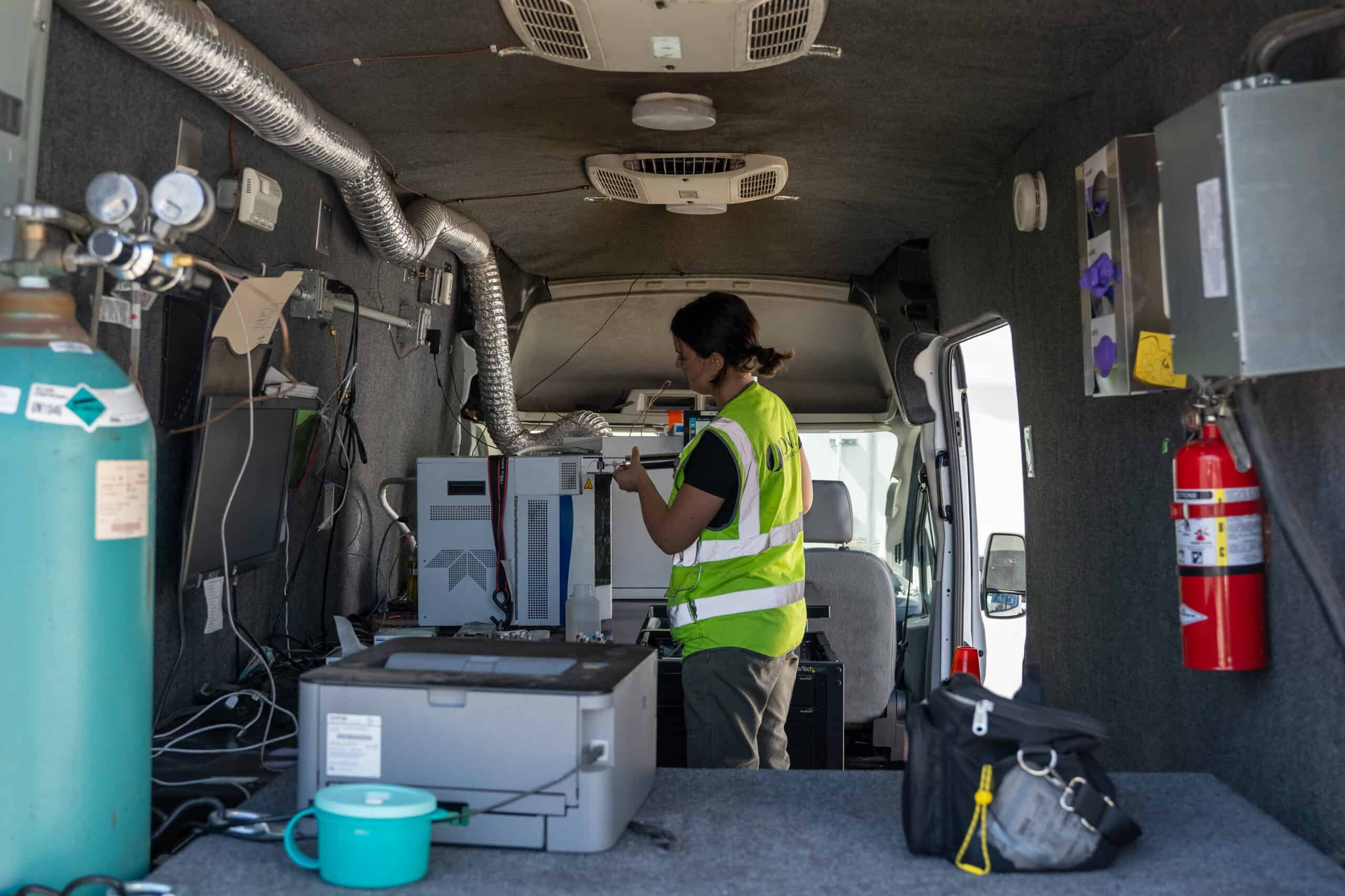 Technician running analyses inside a Jones Environmental mobile lab